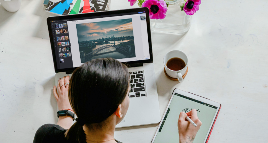 Female designer creating designs on a computer and tablet using Fotor